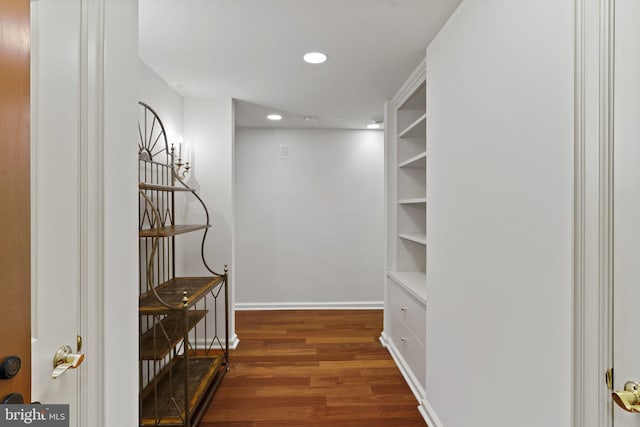 corridor featuring recessed lighting, baseboards, and wood finished floors