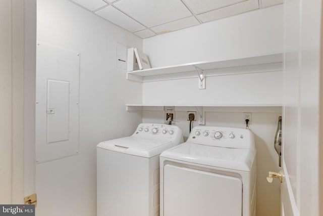 clothes washing area with electric panel, laundry area, and washer and dryer