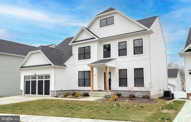 modern farmhouse style home with driveway, an attached garage, a shingled roof, and a front yard