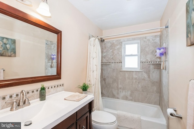 bathroom featuring vanity, toilet, and shower / bath combo with shower curtain