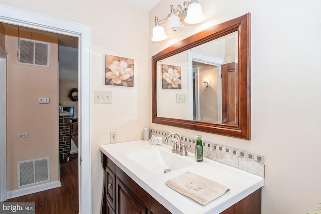 bathroom featuring visible vents, wood finished floors, and vanity