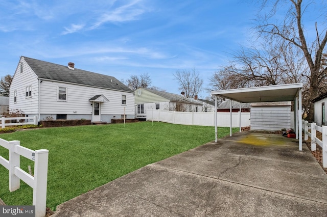 view of yard featuring entry steps, fence, and driveway