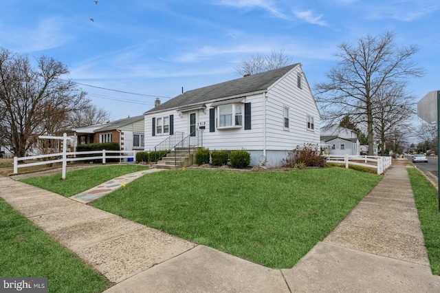 bungalow-style house with a front yard, fence, and roof with shingles