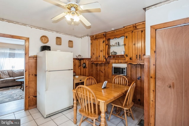 dining space featuring light tile patterned floors and ceiling fan