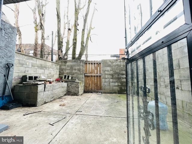 view of patio / terrace featuring fence and a gate