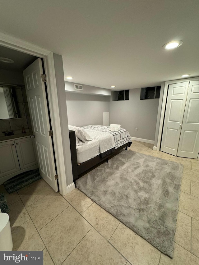 unfurnished bedroom featuring baseboards, light tile patterned floors, visible vents, and recessed lighting