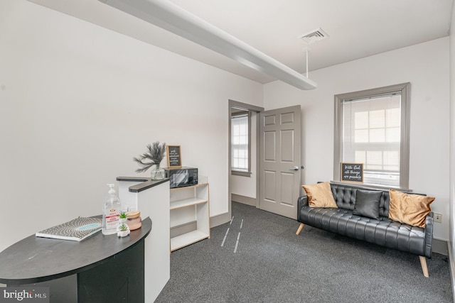 office area with visible vents and dark carpet