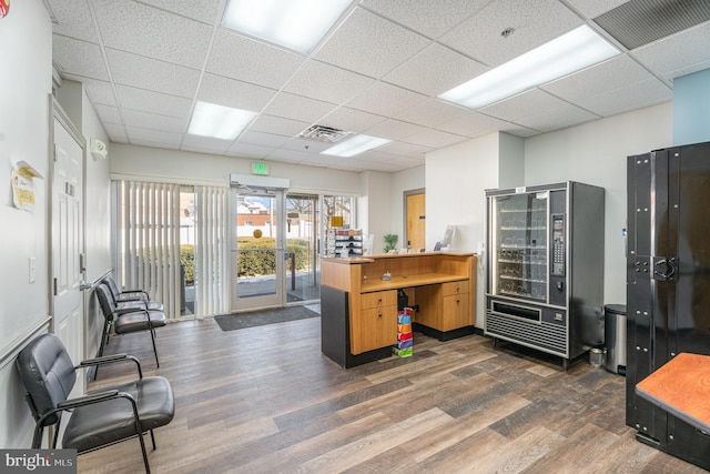 home office featuring dark wood-style floors, visible vents, and a drop ceiling