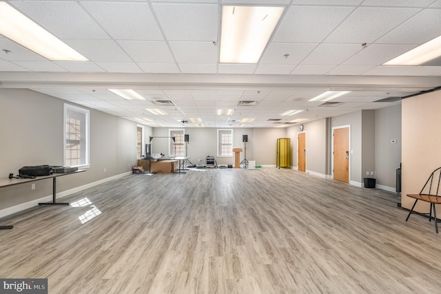 misc room featuring visible vents, a drop ceiling, light wood-style flooring, and baseboards