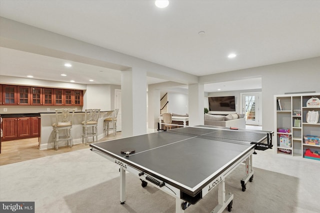 game room featuring light colored carpet, bar area, and recessed lighting