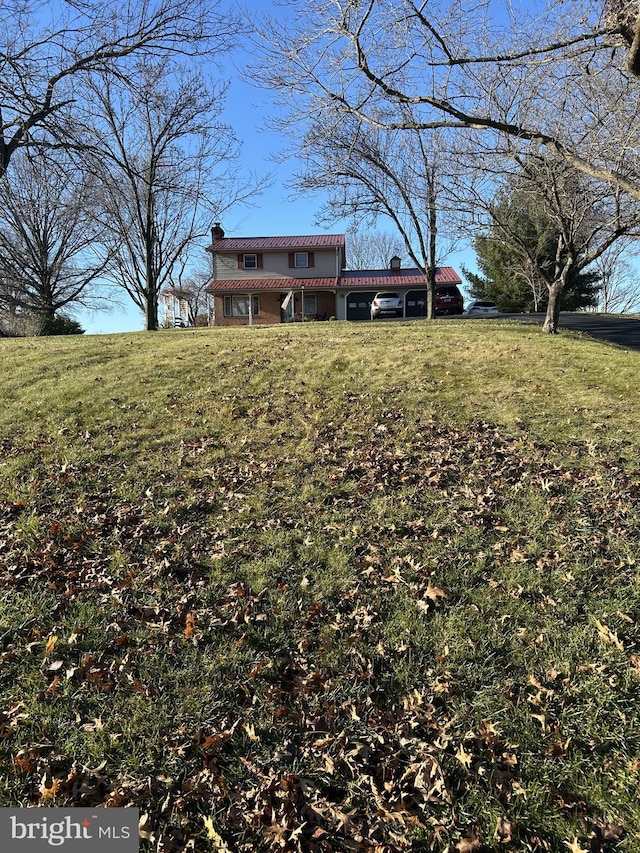 view of front of property featuring a front yard and a chimney