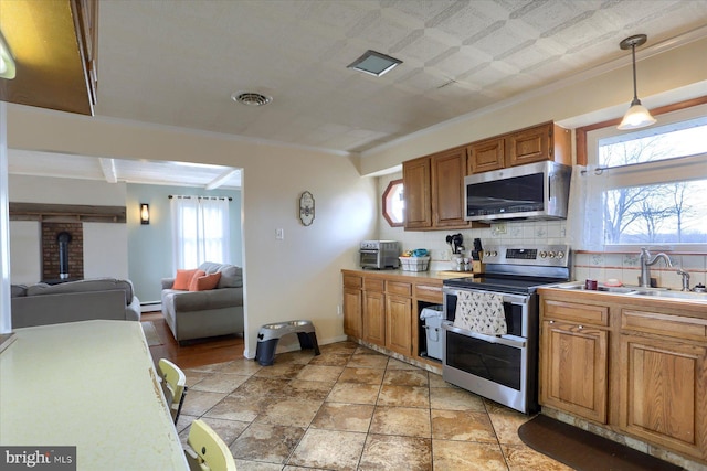 kitchen featuring stainless steel appliances, tasteful backsplash, visible vents, hanging light fixtures, and brown cabinetry