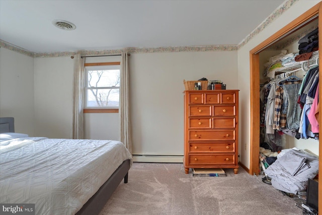 bedroom with light carpet, a baseboard heating unit, a closet, and visible vents