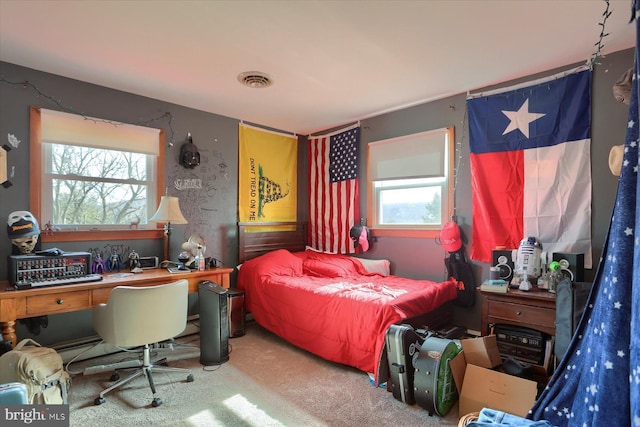 carpeted bedroom featuring multiple windows and visible vents