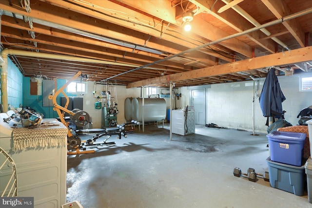 basement with washing machine and dryer and heating fuel