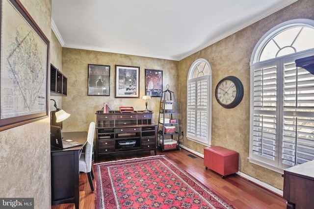 office featuring wood finished floors, a wealth of natural light, and crown molding