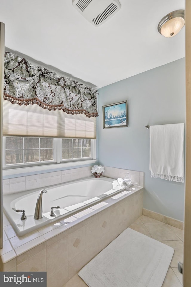 bathroom featuring baseboards, visible vents, a bath, and tile patterned floors