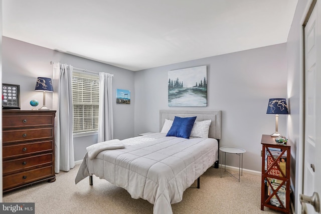 carpeted bedroom featuring baseboards