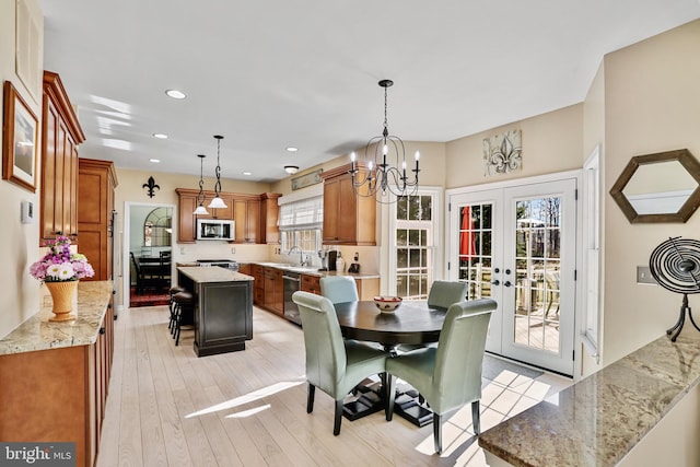 dining room featuring recessed lighting, french doors, and light wood-style flooring