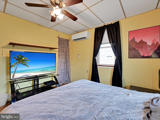 bedroom with ceiling fan and an AC wall unit