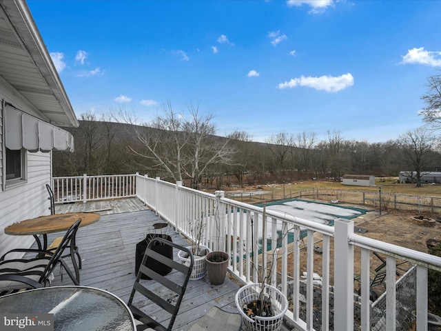 wooden deck featuring fence and a fenced in pool