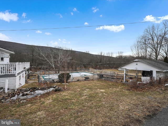 view of yard featuring fence and a mountain view