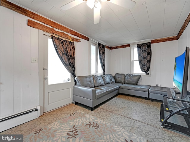 living area with light carpet, a baseboard radiator, a ceiling fan, and crown molding