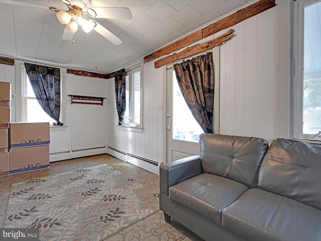 living area featuring ceiling fan and a healthy amount of sunlight