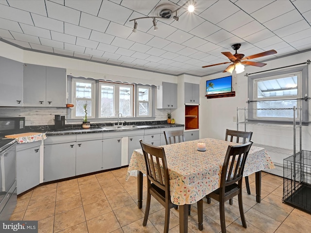 dining room featuring ceiling fan and light tile patterned flooring