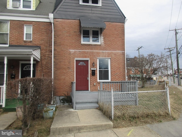 townhome / multi-family property featuring brick siding and fence