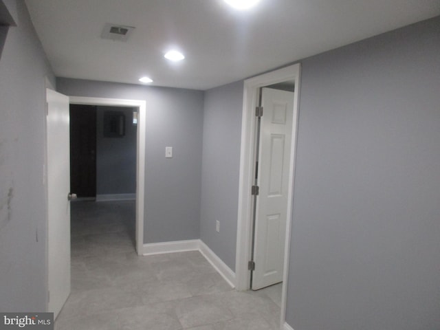 corridor featuring recessed lighting, visible vents, and baseboards