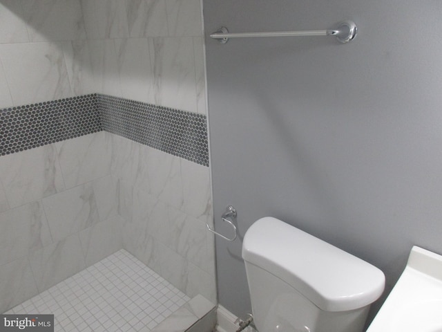 bathroom featuring a stall shower and toilet