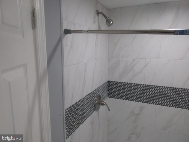 bathroom with tiled shower