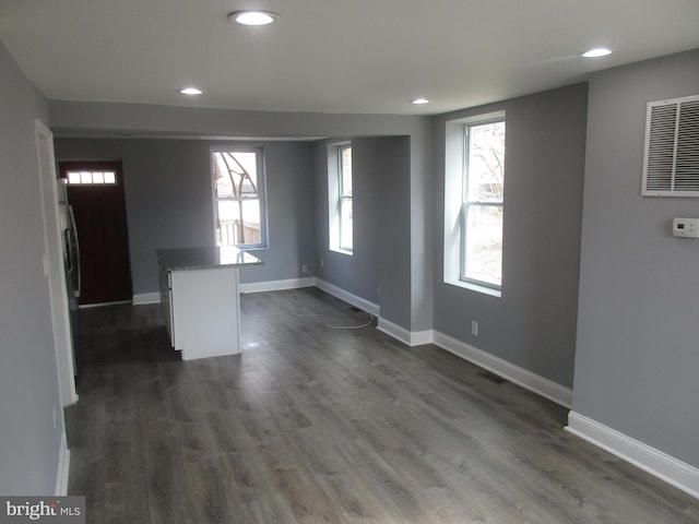 interior space featuring visible vents, baseboards, dark wood-style flooring, and recessed lighting