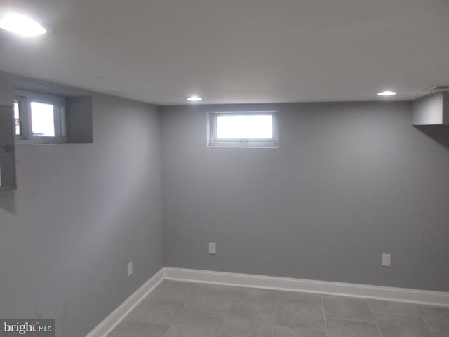 basement featuring recessed lighting, baseboards, and light tile patterned floors