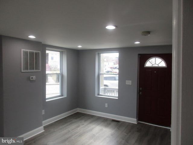 foyer entrance featuring recessed lighting, visible vents, baseboards, and wood finished floors