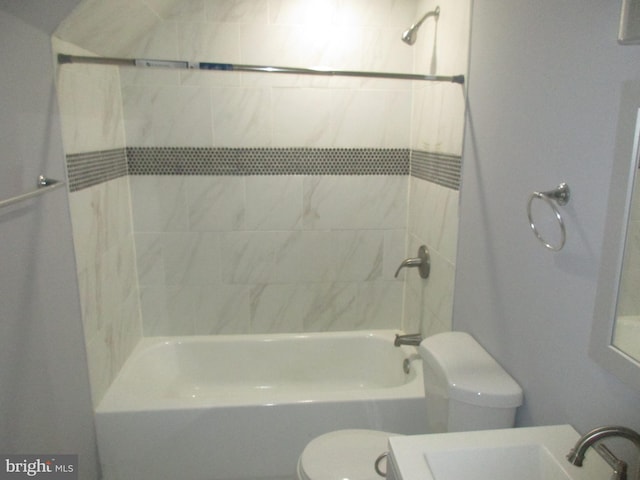 bathroom featuring toilet, a sink, and bathing tub / shower combination