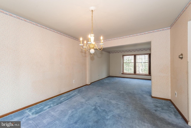 empty room featuring crown molding, a chandelier, baseboards, wallpapered walls, and carpet