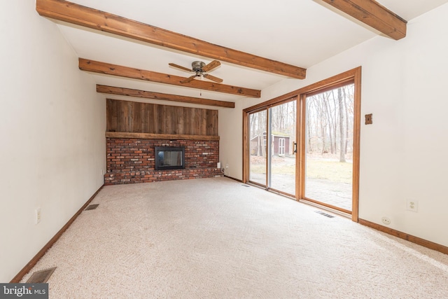 unfurnished living room featuring baseboards, beamed ceiling, visible vents, a ceiling fan, and a fireplace
