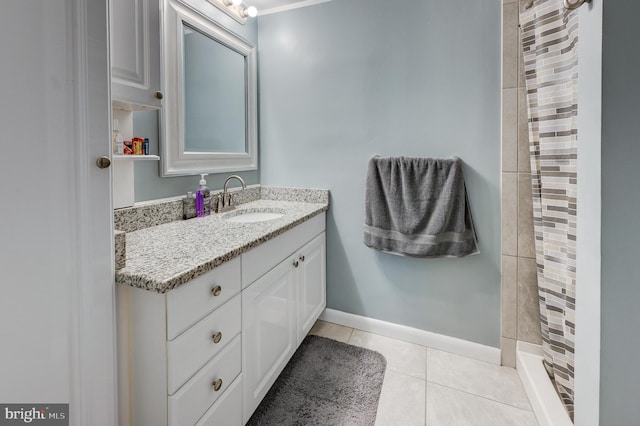 bathroom with tile patterned floors, curtained shower, vanity, and baseboards