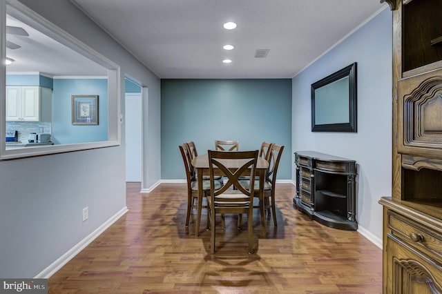 dining space featuring visible vents, recessed lighting, wood finished floors, and baseboards