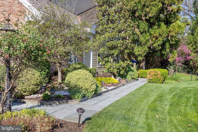 view of side of home featuring a lawn