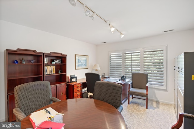 home office with visible vents, track lighting, and baseboards