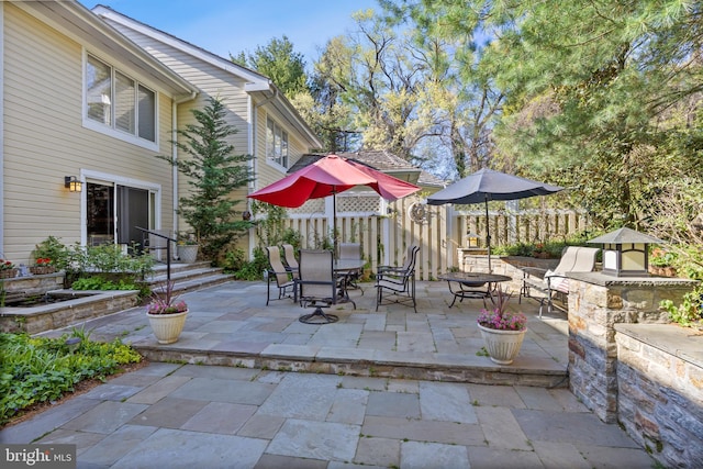 view of patio featuring fence and outdoor dining area