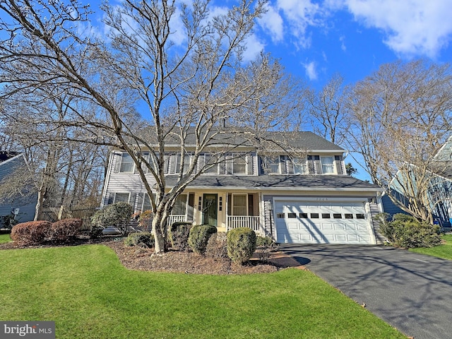 view of front facade featuring aphalt driveway, a porch, a front lawn, and a garage