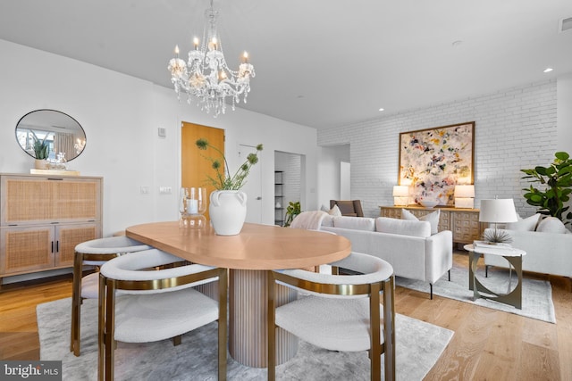 dining area featuring recessed lighting, visible vents, light wood-type flooring, and brick wall