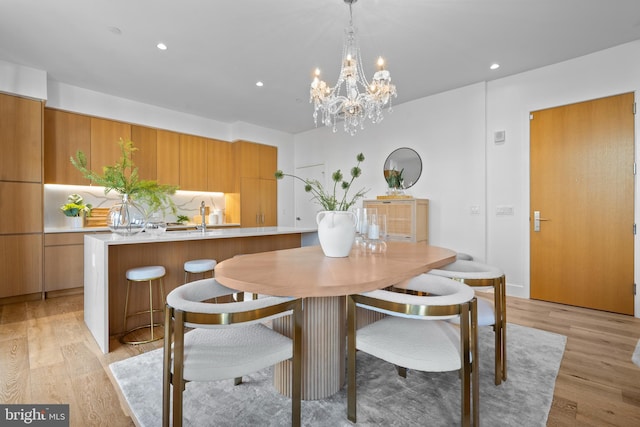 dining room with recessed lighting and light wood finished floors