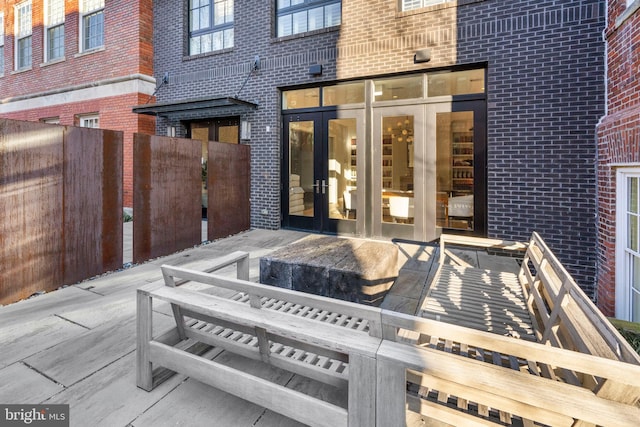 view of patio featuring french doors and fence