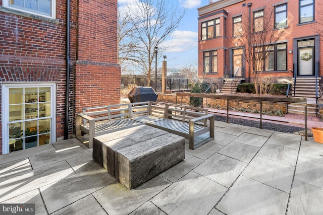 view of patio / terrace featuring a grill and fence