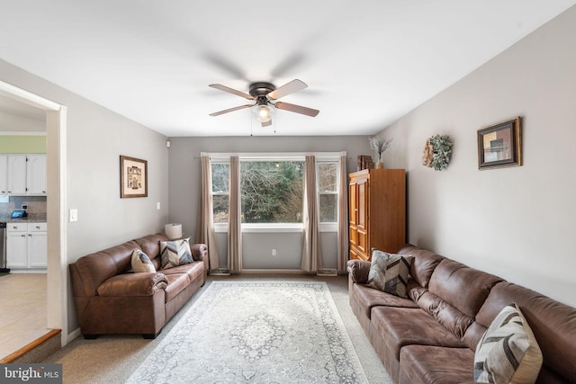 living area with ceiling fan and light colored carpet